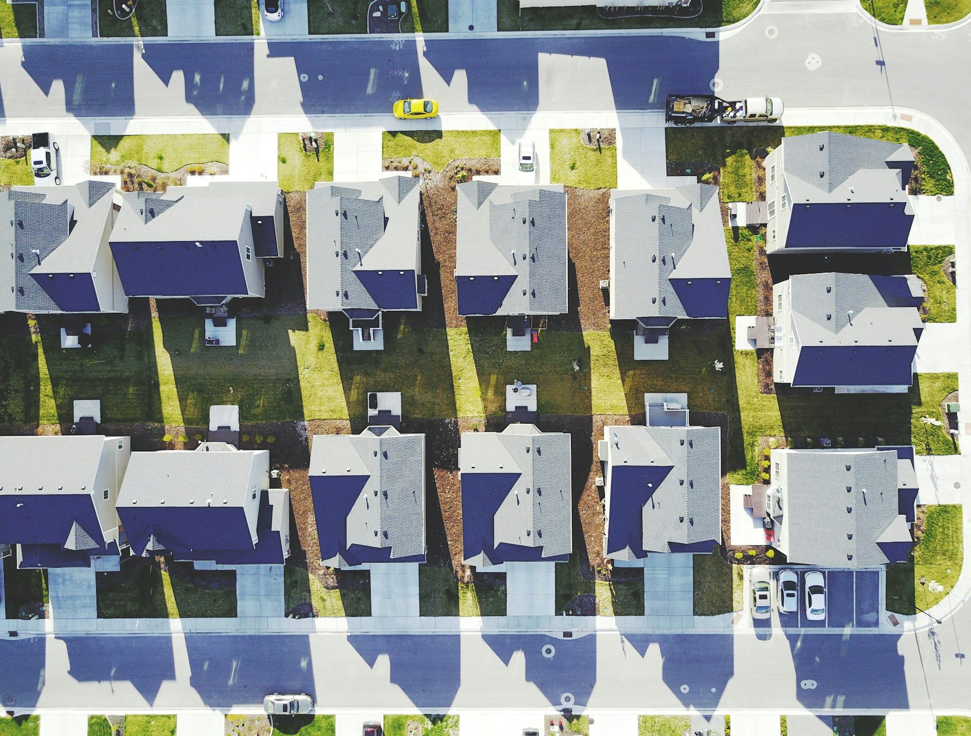 A row of houses for rent, surrounded by a mix of urban and suburban landscapes, ready for a real estate investor to evaluate the properties