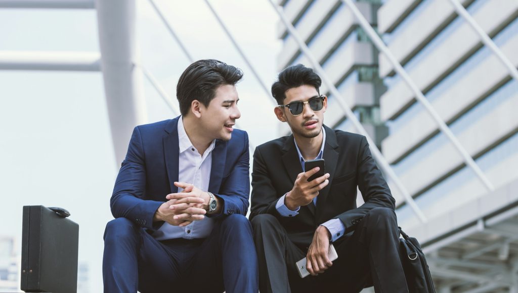 A small-scale real estate investor reviewing financial documents and inspecting a property with a property manager