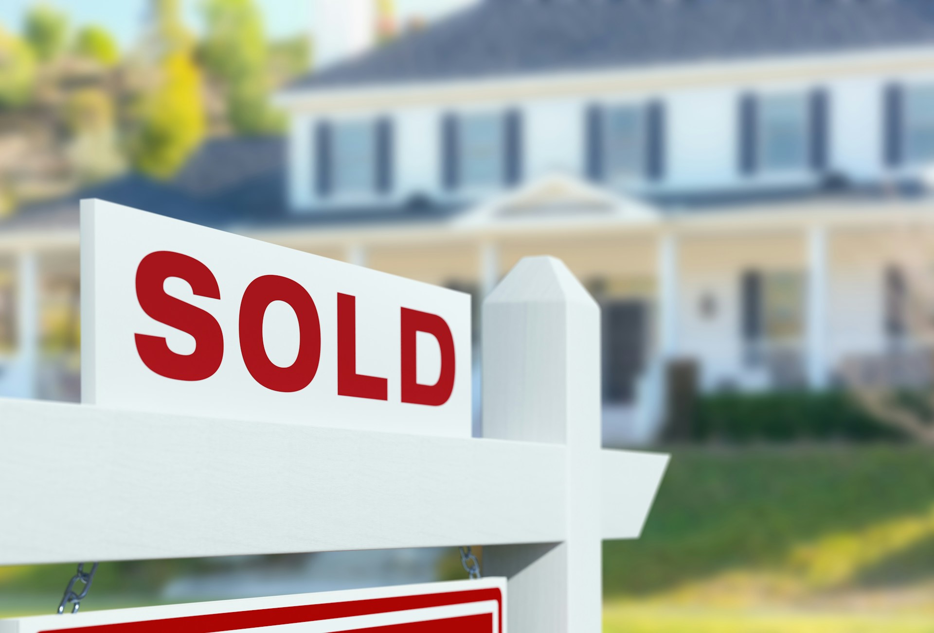 A suburban neighborhood with multiple "For Sale" and "Sold" signs and empty houses, indicating significant savings in real estate