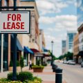 A commercial property with a "For Lease" sign in front, surrounded by growing businesses and increasing foot traffic