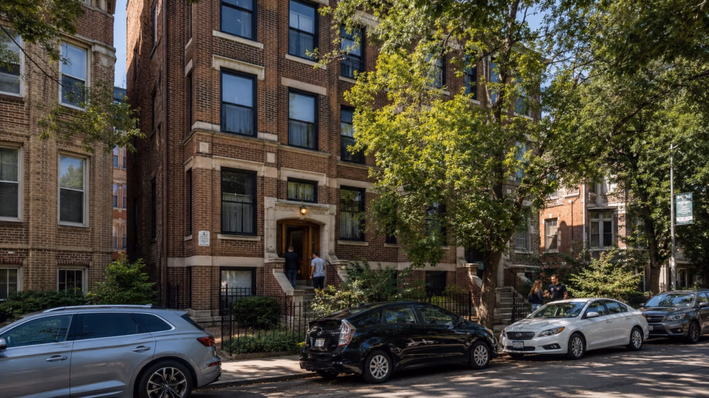 Chicago multifamily rental building on a tree-lined neighborhood street with brick architecture and residential tenants nearby